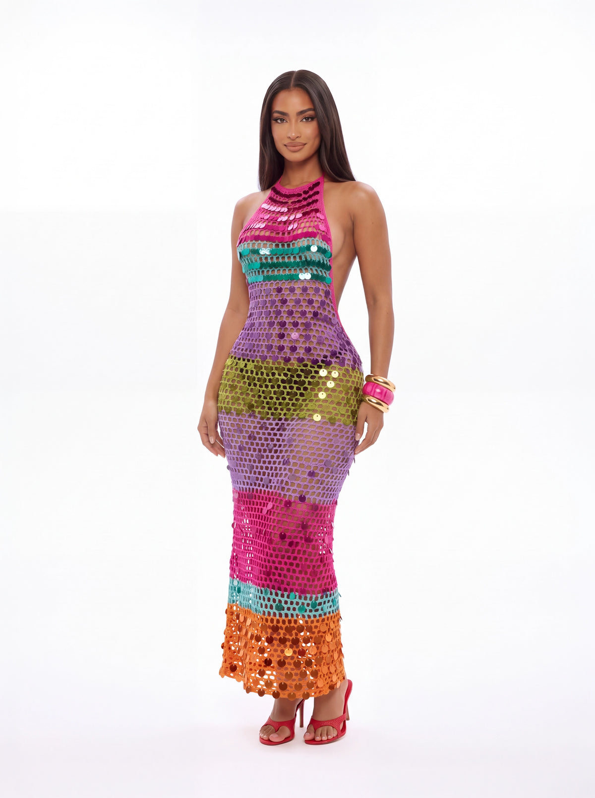 A woman modeling a sleeveless, high-neck, floor-length sequin dress with horizontal color-blocked bands in pink, purple, green, turquoise, and orange on a plain white studio background.