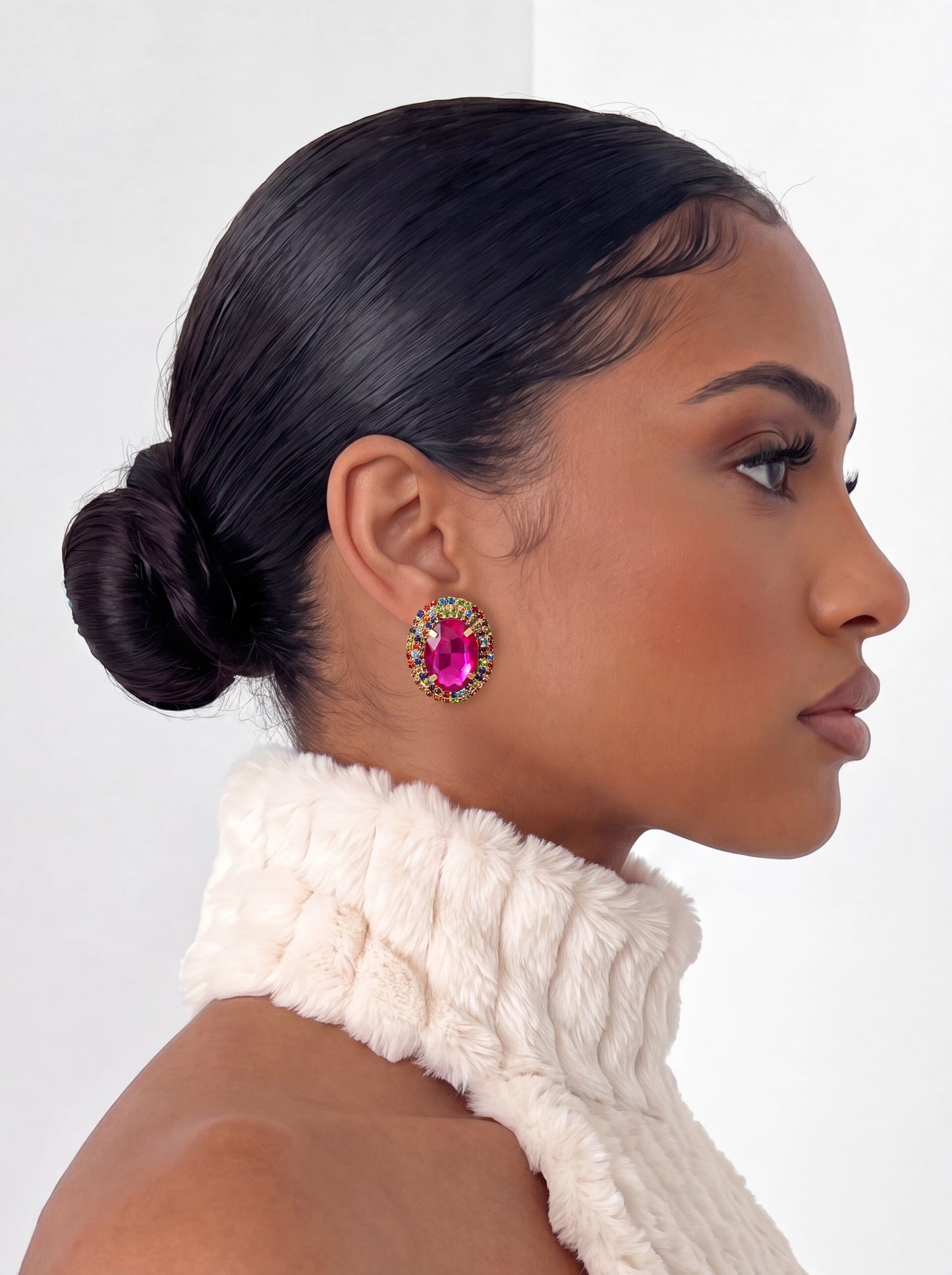 Designed to stand out, these oversized gemstone studs combine radiant pink hues with sparkling crystal detailing for a glamorous, eye-catching finish.