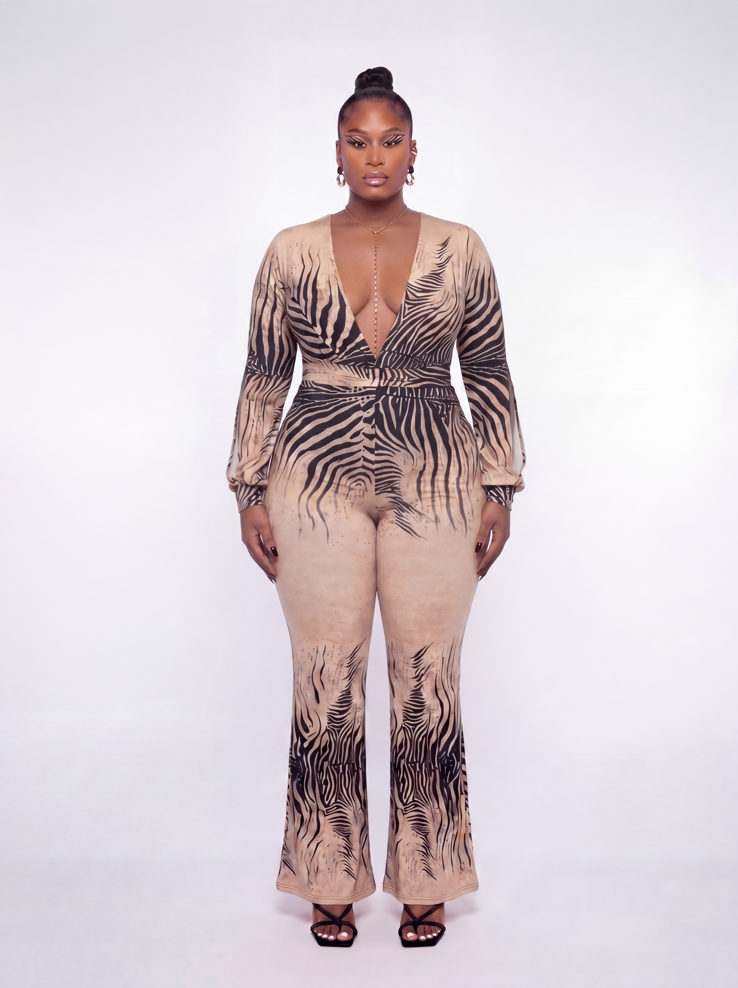 Woman wearing a zebra print jumpsuit on a white background
